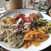 Local delish plate of tempeh curry with rice and 3 other samples of local food.  Vegan if you omit the egg  at Blue Earth Village in Bunutan