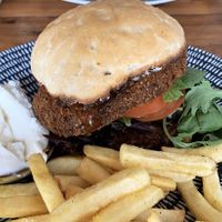 Vegan schnitzel burger with chips and garlic mayo  at Sanctum Cafe in Cooks Hill