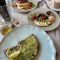Avocado toast, banana bread donut, classic pancakes with Nutella, macchiato   at Manjerica in Lisbon