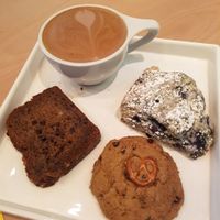 Yum yum mocha (oat milk), bonus coffee, blueberry scone, macadamia chocolate banana bread. at Bonus Bakery in Vancouver