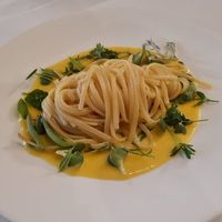 Rice pasta with yellow tomato sauce and assorted aromatics at Antonio Chiodi Latini in Turin