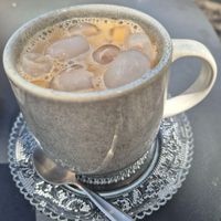 Iced oat latte with caramel syrup $7.00 at Little Mylkbar in Parkville