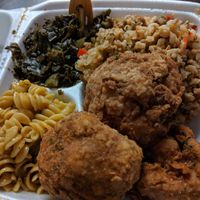 Platter of Mac & cheese, collard greens, dirty rice & very well seasoned, delicious cauliflower balls at Soul Food Vegan in Houston