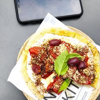 Tiny flatbread (see phone for size reference) at Nola Kitchen in Porto
