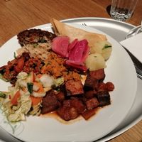 Chilli, kimchi salad, tofu with vegetables, samosa, black bean patty, beetroot, sauerkraut, and potato dumpling at Tibits in Darmstadt
