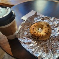Vanilla latte with a cream cheese bagel at Familiars in Brooklyn
