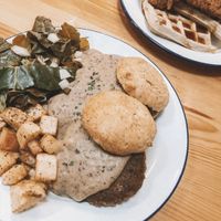 potatoes, biscuits, sosage Pattie, greens & gravy  at Dirty Kitch in Coventry