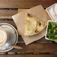 Capuccino with zucchini quiche, salad, and tzatziki at Shizen in Tel Aviv