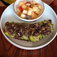 Mushroom avocado on toast served with fruit at Pumpkin Tales in Chennai