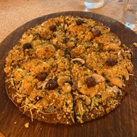 Vegan pizza with olives, courgette, mushrooms and olives on a charcoal base  at La Casa Viva in Valencia