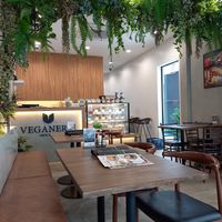Seating area and a display of yummy looking vegan desserts! at Veganerie - Silom in Bangkok