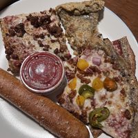 Detroit style meat lovers, mushroom calzone, Georgia peach, breadstick  at Plant Based Pizzeria in Atlanta