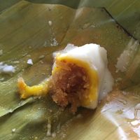 Khanom sod sai - shredded coconut filling inside steamed coconut cream at Jay That Phanom in Nakhon Phanom