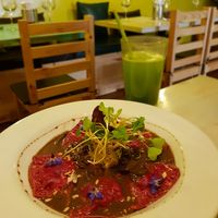 Beetroot ravioli with wild mushrooms and spinach in mushroom gravy, rocket, sunflower seeds and flowers. Ginger lemonade. at Rucula in Cusco