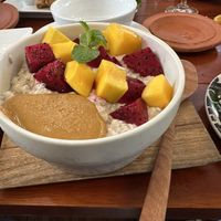 Overnight oats with peanut butter, mango, dragon fruit, and banana at the bottom   at Coffee Station in Phong Nha