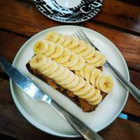 Dark bread with peanut butter and banana. Not on menu, but you can ask the owner. It's delicious. at Coffee Station in Phong Nha