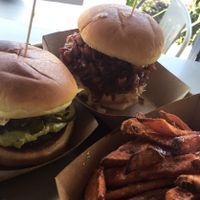 On the left is the nacho daddy burger and on the left is the pulled pork sandwich with sweet potato fries! at The Brave Bean in Fountain Valley