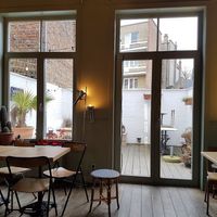 upstairs interior and outdoors seating in the back at Paula Mostaert in Bruges