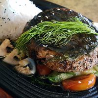 Fish imitation with Lolot leaf, dill, tomatoes and zucchini on rice at Sunshine Vegan Restaurant in Berlin