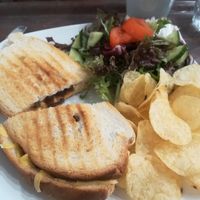 Vegan cheese and Red onion chutney toastie with crisps and salad.  at Monk's Kitchen Cafe in Gloucester