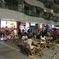 Sidewalk tables with a light breeze from the sea at Casa de Nara in Joao Pessoa