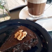 Perfect combo (for a sweet tooth): banana cacao and walnut cake + cappuccino (with almond milk). at Casa de Nara in Joao Pessoa