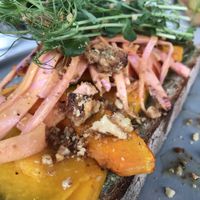 Sourdough bread, pumpkin seed butter, grilled pumpkin, pickled ramenas and caramelised walnuts  at Camion in Antwerpen
