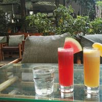 Fresh watermelon and orange juice and outdoor seating area at Forest & Plate in Kathmandu