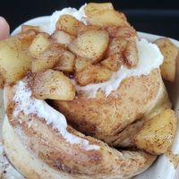 Cinnamon roll with vanilla frosting and cinnamon apples on top! at Cinn City in Lynchburg