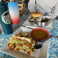 Flautas with charro beans, beyond burger also pictured at Veggie Del Sol in Brownsville