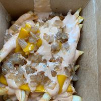 Animal fries (fries topped with thousand island, cheese, and grilled onions) at Plant Slayer in Fresno