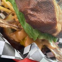 Campfire burger (burger topped with cheese, lettuce, pickles, onion rings, bacon, and campfire sauce) at Plant Slayer in Fresno