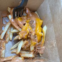 Campfire fries (fries topped with cheese, grilled onions, and campfire sauce) at Plant Slayer in Fresno