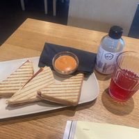 Three ham and cheese toasts and „Isas kombucha“ bottle  at Veganika in Ljubljana
