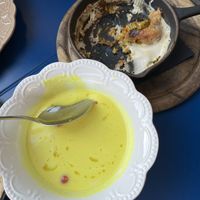 Lemon soup (must try!) and part of the bread dumplings with garlic sauce and chimichuri (also insane)  at Veganika in Ljubljana