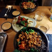 Lažniči (tempeh BBQ skewers with cabbage), Soba 103 (soba noodles with kimchi, peanut sauce, wakame, edamame, fried tempeh, onions, chilli peanuts, spinach) at Veganika in Ljubljana