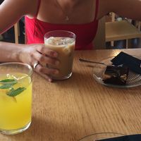 The lemonade in the forground and the brownie and ice coffee further back. at Veganika in Ljubljana