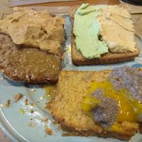 Breakfast buffet example. Bread, banana bread, and different spreads, f.e. Hummus, green tofu paste, Chía pudding. Peanut butter and doce de leite de coco. at Tita Bistro in Rio De Janeiro