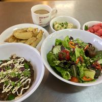 Local greens, fresh fruit, Oven Fries, chickpea salad, chili bowl at One Grub Community in El Paso
