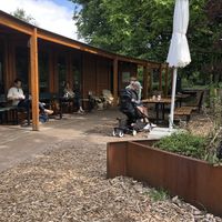 Seating area outside, with a view on the park at Vroesenpaviljoen in Rotterdam