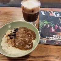A breakfast porridge (with date jam and blackcurrants, so good!!!), a hot chocolate and a vegan magazine   at VegB12 in Tallinn