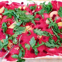 Tarte flambée with beetroot hummus, beetroot, peaches, rocket and walnuts at Wilma Wunder in Dusseldorf