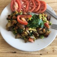 Tofu hash with sliced tomatoes  at Bluegrass Grill in Chattanooga