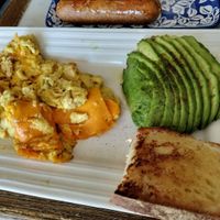 Vegan scrambled eggs with cheese, avocado, bread, and a side of sausage. at Filoncino Cafe in Staten Island