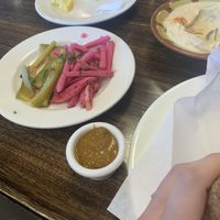 Hot sauce, hummus, and a pickles plate at Byblos Restaurant in Gainesville