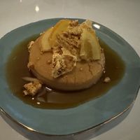 Flan dessert with toasted “honeycomb” and candied orange slices as a garnish   at Bistro Tendresse in Montreal