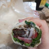 Falafel wrap with lettuce, tomato, onion and the housemade hot sauce. at Jerusalem Market on Elm in Greensboro