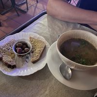 Bread with tahini and olives on the side (left), vegetable soup (right)   at Casa da Horta in Porto
