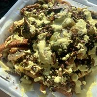 Philly cheesesteak fries. Not photogenic but 11/10 for taste. at Evolve Modern Vegan Kitchen in Daytona Beach
