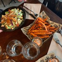 Caesar salad and potato fries at Mad Mad Vegan - Chueca in Madrid
